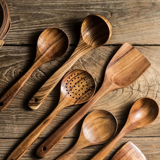 Set of wooden cooking utensils on a rustic wooden surface