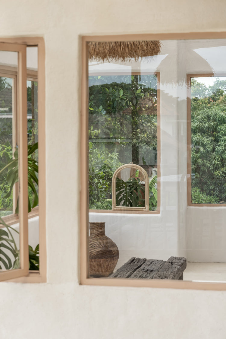 Handmade arch rattan wall mirror with natural boho decor, featuring a woven rattan frame and stylish design.