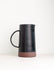 Multi-colored ceramic pitcher by Black Oak Art, featuring a modern design with vibrant hues, perfect for serving or decorative use.