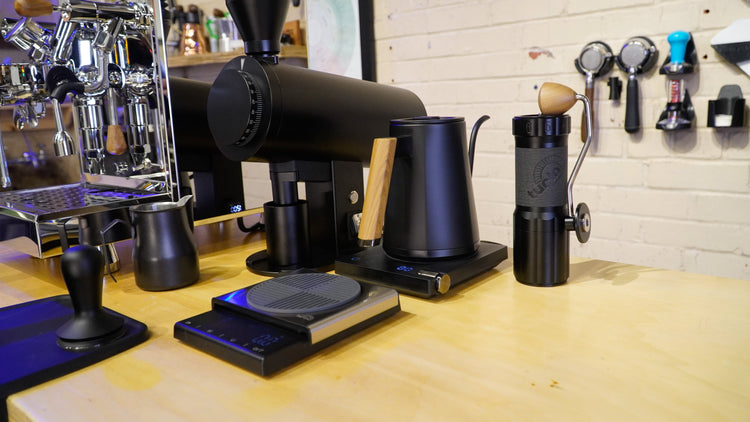 Turin Electric Pour Over Kettle by Espresso Outlet LLC with stainless steel body and ergonomic handle on a kitchen counter.