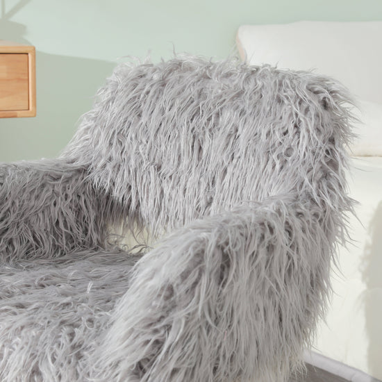 Grey faux fur upholstered dining chair with metal legs, showcasing a modern and plush design for stylish dining spaces.