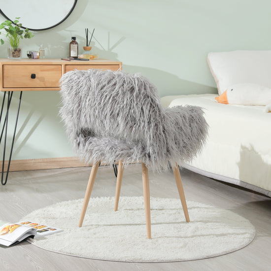 Grey faux fur upholstered dining chair with metal legs, modern design, comfortable seating for dining rooms.