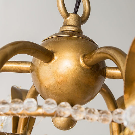 Early American-style Mooiehome chandelier with 25.2-inch ornate metal frame and multiple candle-style light holders.