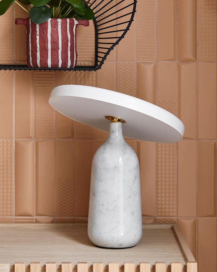 Mooiehome Eddy 12.6-inch table lamp with a modern design, featuring a sleek base and a fabric lampshade on a wooden table.