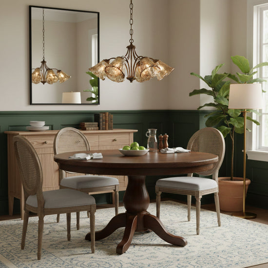 Elvarin chandelier by Mooiehome featuring elegant glass and metal design, hanging from a ceiling with warm lighting.