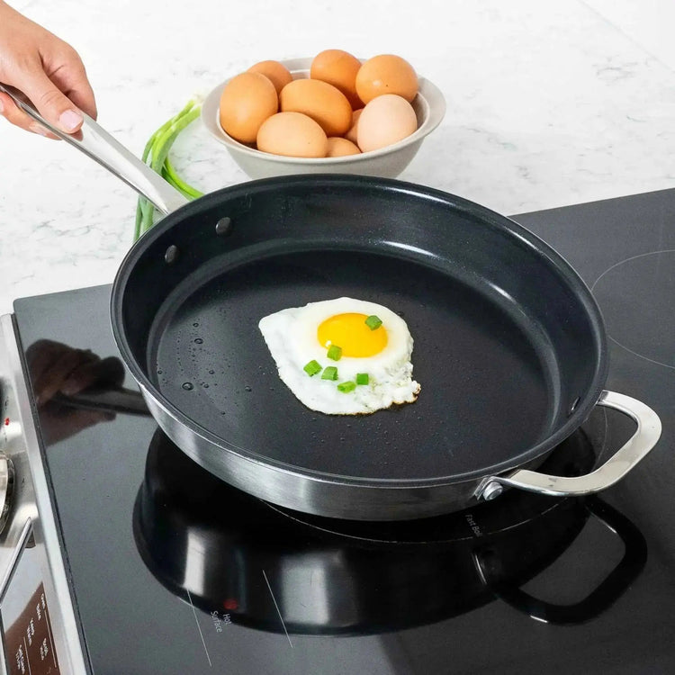 Alva Cookware frying pan with non-stick surface and ergonomic handle, shown on a kitchen countertop.