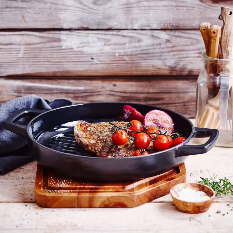 11-inch Alva Cookware grill pan with ridged surface for grilling and searing, shown with handles and non-stick coating.
