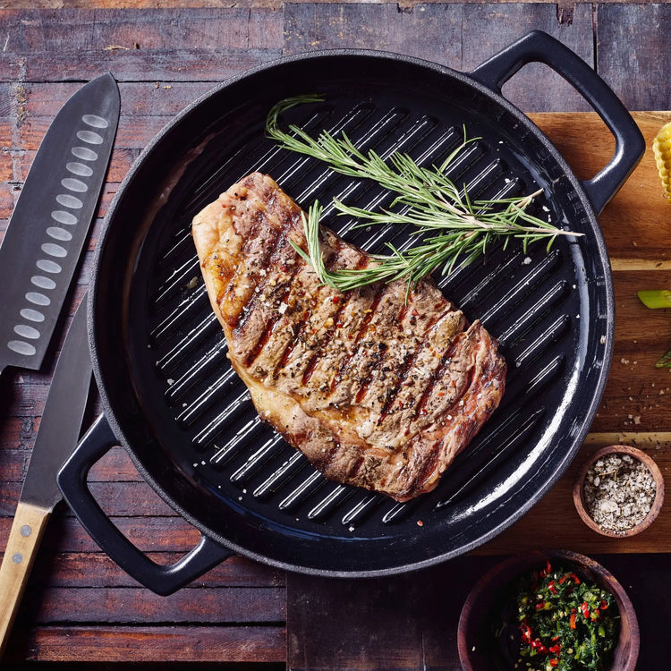 11-inch Alva Cookware grill pan with ridged surface for grilling indoors, made of durable material for even heat distribution.