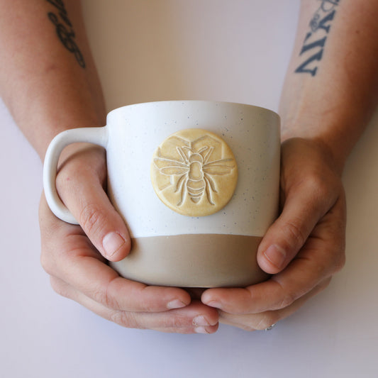 Ceramic bee-shaped mug by Prodigal Pottery with detailed honeybee design and smooth glaze finish.