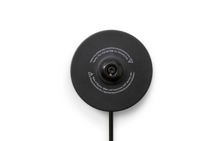 Black base of the BALMUDA The Kettle, a sleek electric kettle by BALMUDA USA, with a modern design and smooth finish.