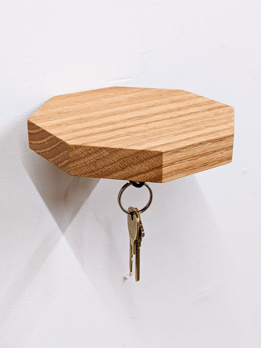 Wooden octagon key hook shelf in oak, NookWoodworking entryway wall shelf with hooks for keys and small accessories.