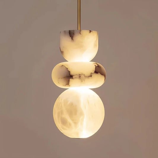 Alabaster pendant light chandelier by DECORBITES hanging from ceiling with a smooth, rounded alabaster shade and modern design.