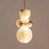 Alabaster pendant light chandelier by DECORBITES hanging from ceiling with a smooth, rounded alabaster shade and modern design.
