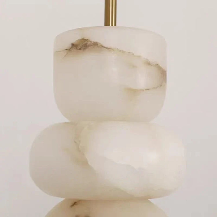Alabaster pendant light chandelier by DECORBITES hanging from ceiling with a smooth, rounded alabaster shade and modern design.