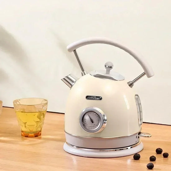 SmartPursue™ electric kettle with built-in thermometer, stainless steel body, and ergonomic handle for precise boiling.