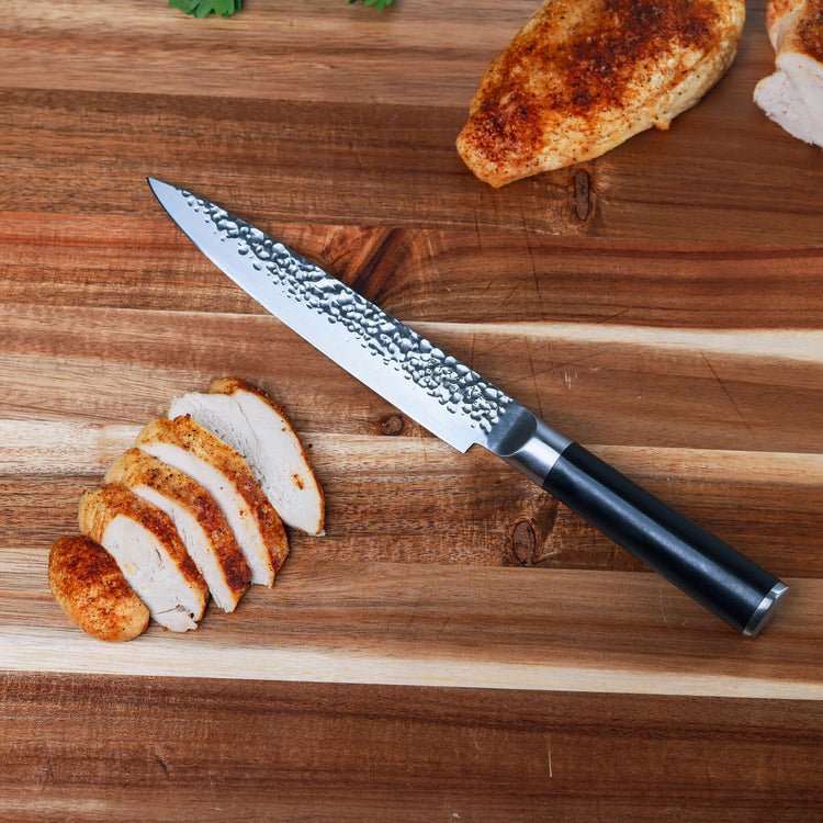 Swiss Diamond 8-inch hammered carving knife with a sharp stainless steel blade and ergonomic handle for precise slicing.