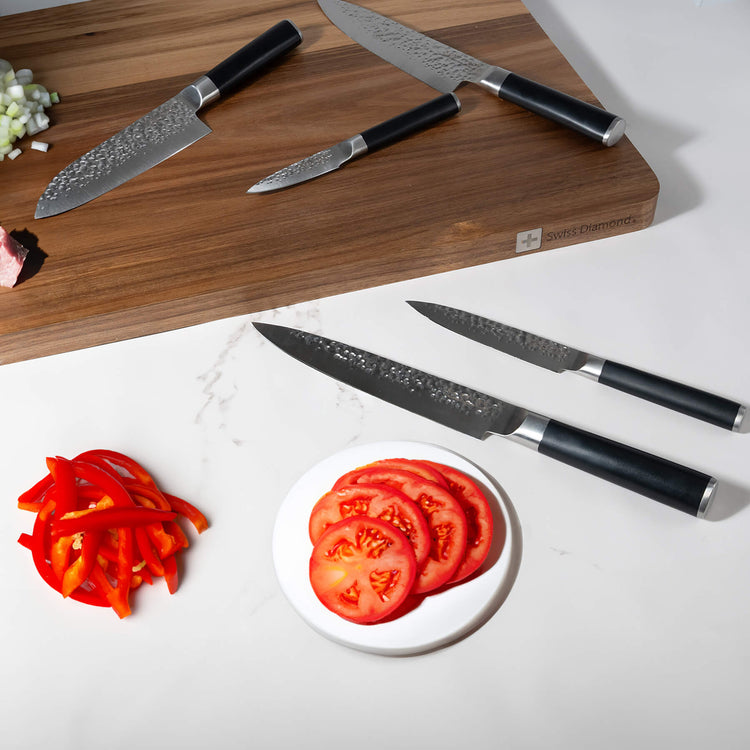 Swiss Diamond hammered 5-piece knife set with wooden handles displayed on a kitchen countertop.