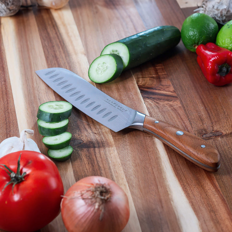Swiss Diamond 7-inch Damascus Santoku Knife with a sharp, patterned blade ideal for slicing and dicing in the kitchen.