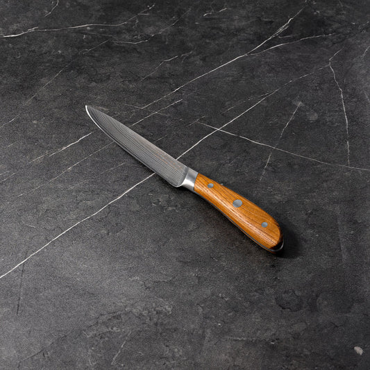 Swiss Diamond 5-inch Damascus utility knife with a sharp, patterned blade and ergonomic handle for versatile kitchen use.