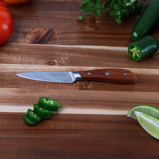 Swiss Diamond 4-inch Damascus paring knife with a sharp blade and ergonomic handle, ideal for precise kitchen prep.