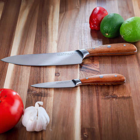 Swiss Diamond Damascus Chef Paring Set with three high-quality paring knives on a cutting board.