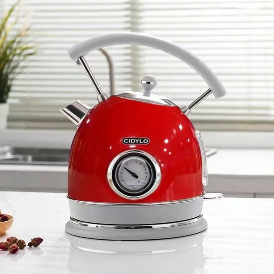 SmartPursue™ electric kettle with built-in thermometer, stainless steel body, and ergonomic handle for precise boiling control.