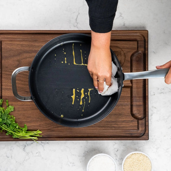 Alva Cookware 4-quart sauté pan with lid, stainless steel skillet for frying and sautéing, shown on stovetop.