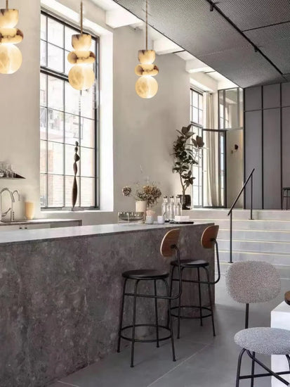 Alabaster pendant light chandelier by DECORBITES hanging from a ceiling, showcasing its elegant design and warm glow.