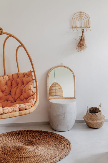 Handmade arch rattan wall mirror with natural boho decor style, featuring intricate woven rattan frame.