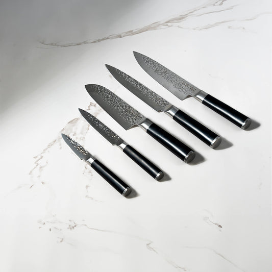 Swiss Diamond hammered 5-piece knife set with white marble handles, featuring chef, bread, paring, utility, and carving knives.