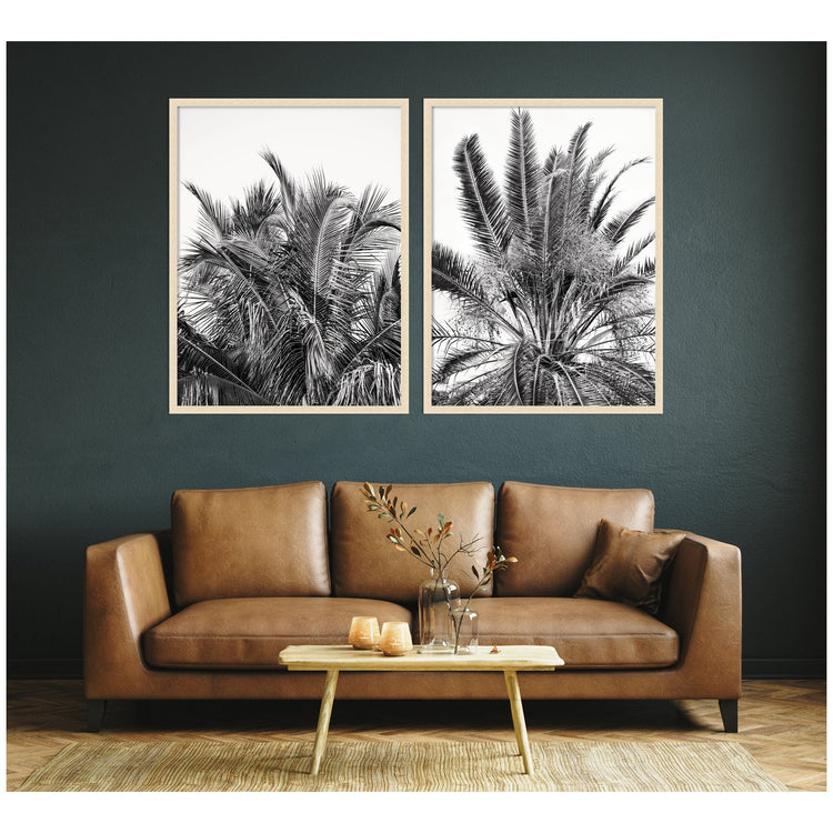 Two framed wall art pieces from the Alicia Bock Palm 2-Piece Set by kateandlaurel, featuring botanical palm designs on neutral backgrounds.