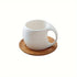 White mug with wooden coaster on a white background