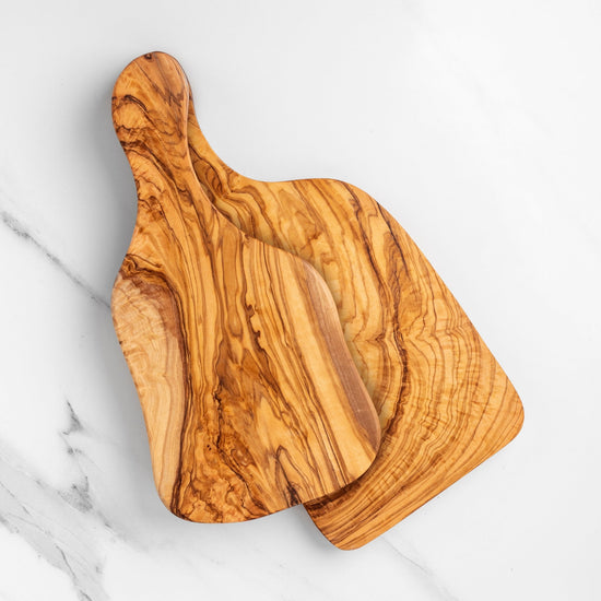 Wooden cutting board with a unique grain pattern on a marble surface