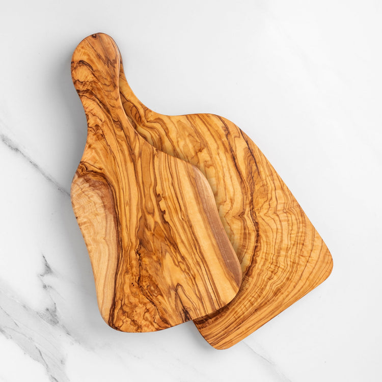 Wooden cutting board with a unique grain pattern on a marble surface