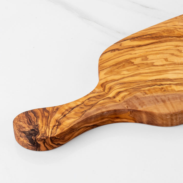 Wooden cutting board with a handle on a white background