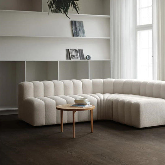 Off-white modern curved sofa by FLIPSTYLEZLLC, plush lamb velvet sectional couch with sleek, contemporary design.