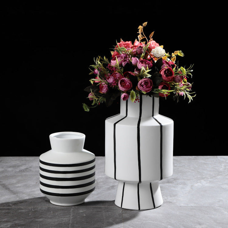 Black and white striped ceramic vase by FLIPSTYLEZLLC, modern light luxury home decor with sleek striped design.