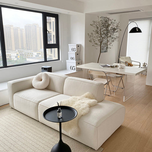 Modern L-shape velvet sofa in tofu fabric, showcasing a stylish sectional design with plush cushions and sleek upholstery.