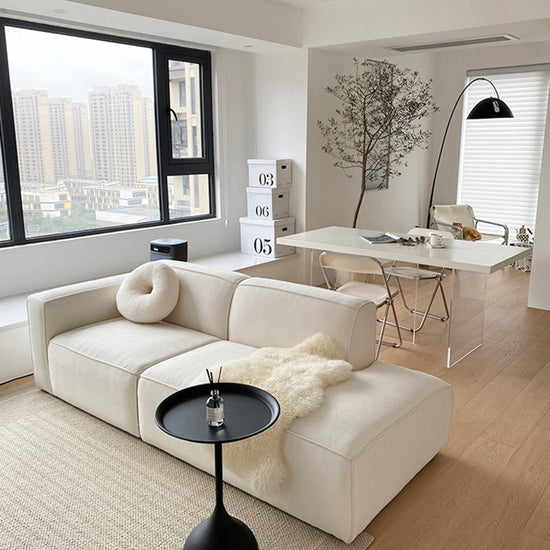 Modern L-shape velvet sofa in tofu fabric, showcasing a stylish sectional design with plush cushions and sleek upholstery.