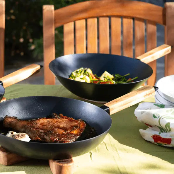 12-inch Alva Cookware carbon steel wok pan with a wooden handle, ideal for stir-frying and Asian cuisine cooking.