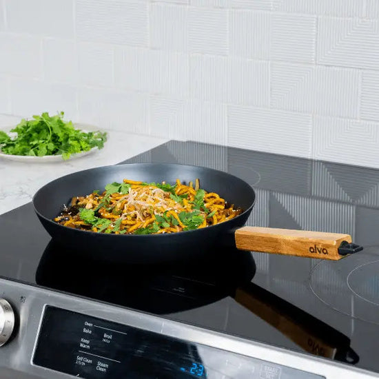 Alva Cookware forest carbon steel frying pan with wooden handle, ideal for stovetop cooking and even heat distribution.