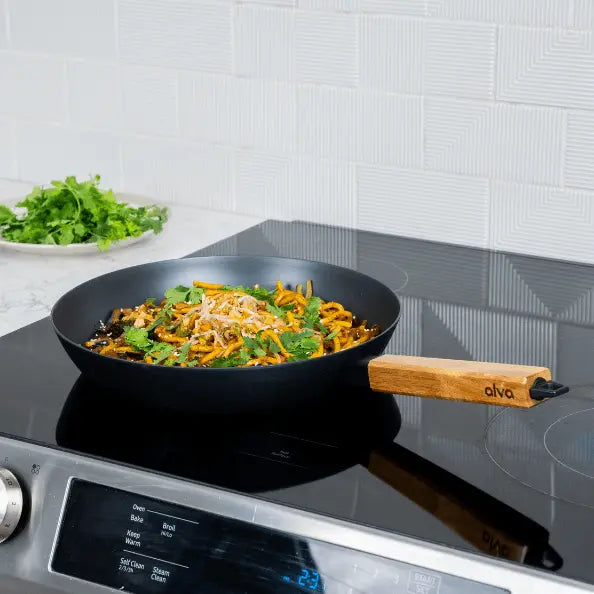Alva Cookware forest carbon steel frying pan with wooden handle, ideal for stovetop cooking and even heat distribution.