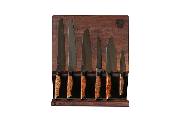 Full kitchen set by STEELPORT Knife Co. including knives, utensils, and cookware arranged on a countertop.