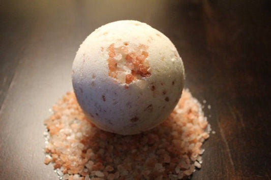 Bath bomb on a bed of pink Himalayan salt crystals