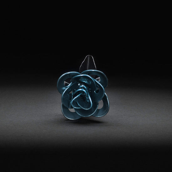 Light blue and black recycled metal immortal rose from Turquoise Poppy, with steel petals, perfect for home and garden decor.