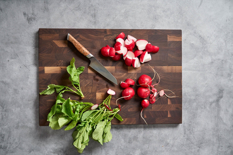 SteelCore™ Cutting Board by STEELPORT Knife Co. in 18x12 inches with a paring knife on a durable metal surface.