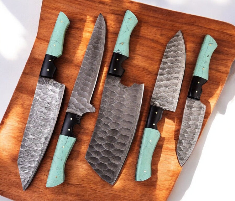 Handmade Damascus kitchen knives set with epoxy resin handles, featuring sharp blades and elegant craftsmanship.