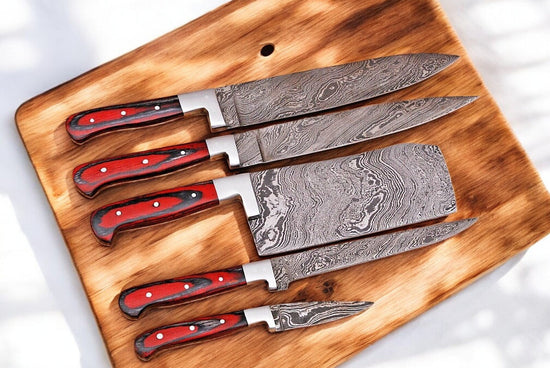 Handmade Damascus kitchen knives set with durable blades, featuring intricate patterns and ergonomic handles for precise cutting.