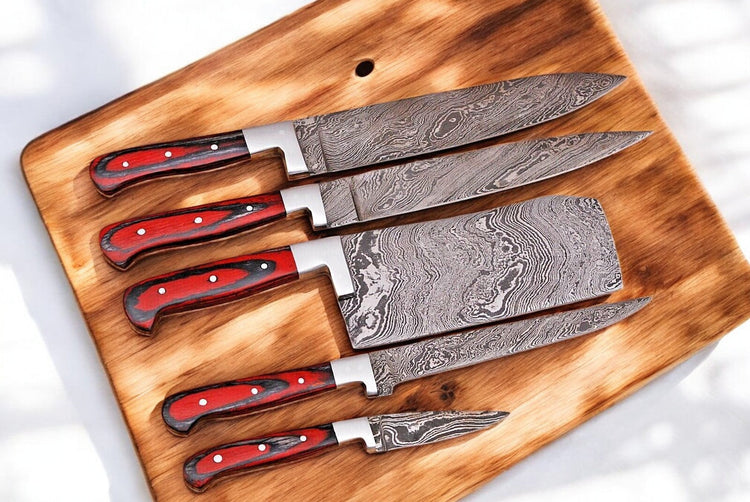 Handmade Damascus kitchen knives set with durable blades, featuring intricate patterns and ergonomic handles for precise cutting.