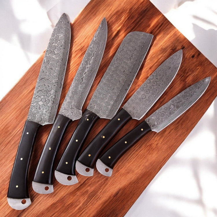 Handmade Damascus kitchen knives set with buffalo horn handles, featuring polished blades and traditional craftsmanship.